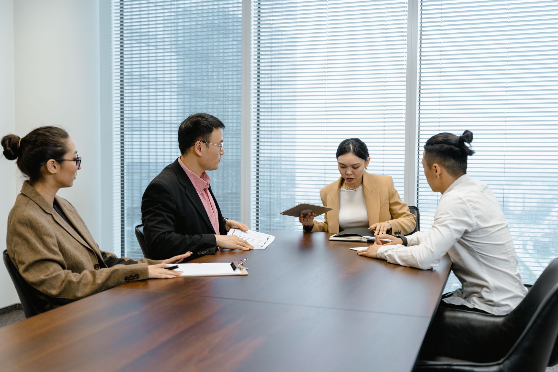 A diverse group of professionals in a boardroom meeting